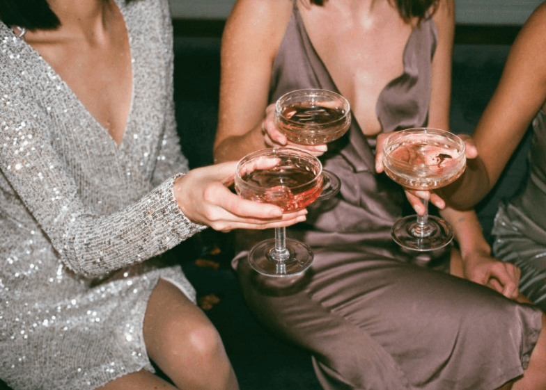 women toasting champagne - how to be more confident as an introvert