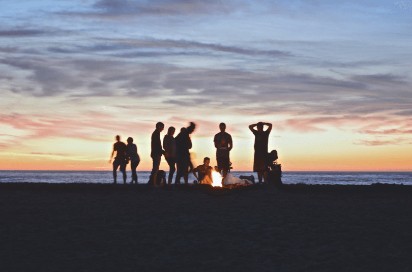 group of people partying on the beach - What is an extrovert and introvert 